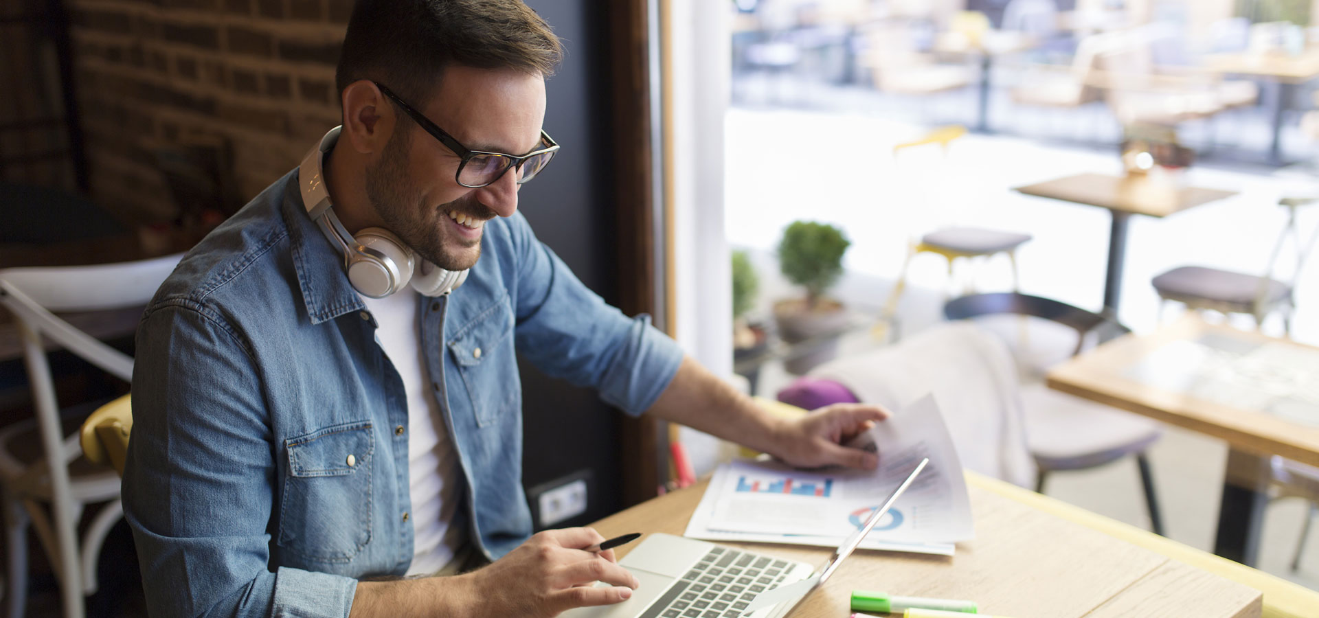 Man sitting at table working on a laptop